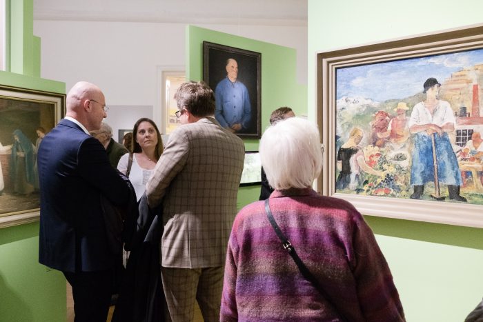 In einer hell erleuchteten Grazer Kunstgalerie werden Gemälde aus den Jahren 1918-1938 betrachtet.
