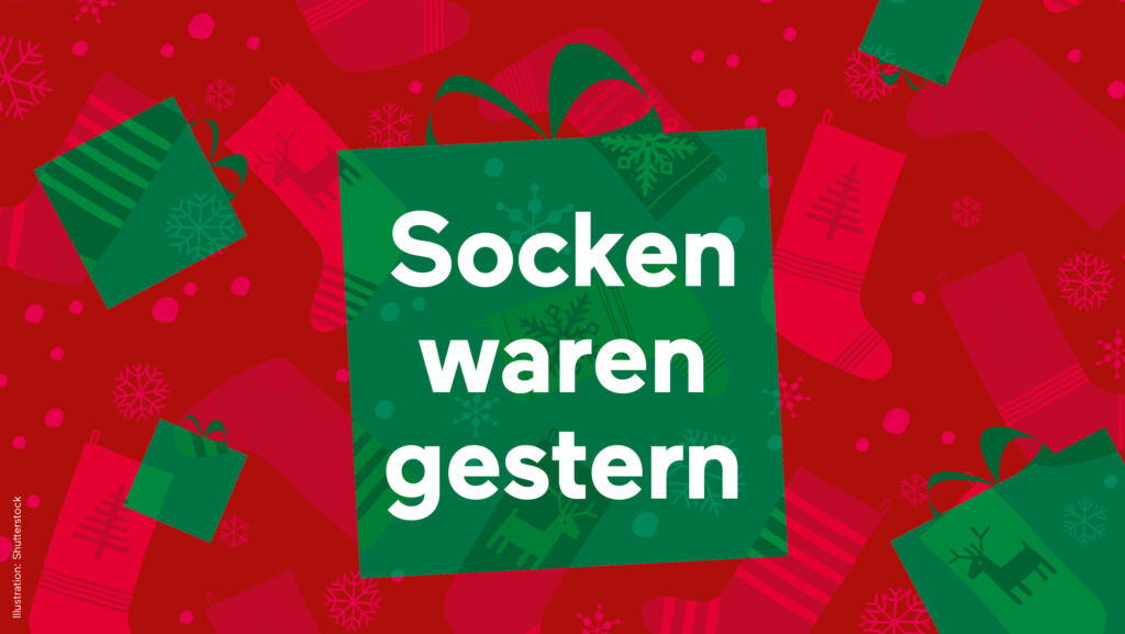 Grüne Schachtel mit deutschem Text Socken waren gestern, der das 1+1-Gratisangebot auf einem festlichen Rot hervorhebt.